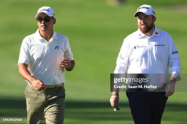 Jason Day of Australia and Shane Lowry of Ireland walk the 15th fairway during the first round of The American Express at La Quinta Country Club on...