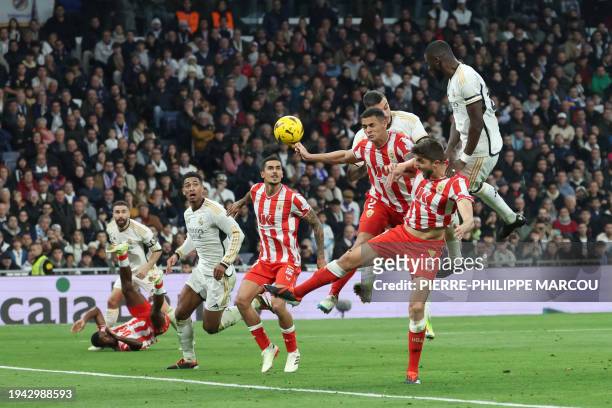 Real Madrid's German defender Antonio Rudiger jumps for the ball next to Almeria's Brazilian defender Kaiky during the Spanish League football match...