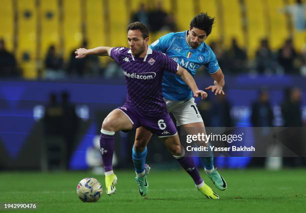 Arthur of ACF Fiorentina battles for possession with Giovanni Simeone of SSC Napoli during the Italian EA Sports FC Supercup semifinal match between...