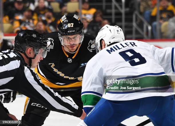 Sidney Crosby of the Pittsburgh Penguins takes a face-off against J.T. Miller of the Vancouver Canucks at PPG PAINTS Arena on January 11, 2024 in...