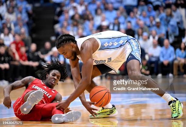 Jae'Lyn Withers of the North Carolina Tar Heels battles Ty-Laur Johnson of the Louisville Cardinals for a loose ball during the game at the Dean E....