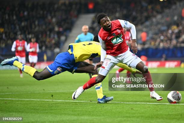 Reims' French defender Mamadou Diakhon fights for the ball with Sochaux French defender Dalangunypole Gomis during the French Cup round of 32...