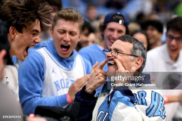 North Carolina Tar Heels fans shows off his Carolina blue teeth for the student section during the first half of the game against the Syracuse Orange...