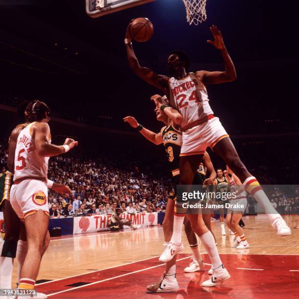 Moses Malone of the Houston Rockets rebounds a shot against Jack Sikma of the Seattle SuperSonics during a game at The Summit on January 27, 1979 in...