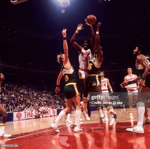 Moses Malone of the Houston Rockets drives to the basket against Paul Sikma and Paul Silas of the Seattle SuperSonics during a game at The Summit on...