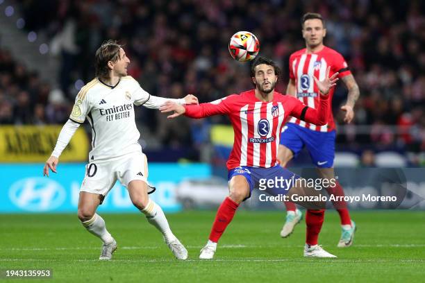 Luka Modric of Real Madrid battles for possession with Mario Hermoso of Atletico Madrid during the Copa del Rey Round of 16 match between Atletico...