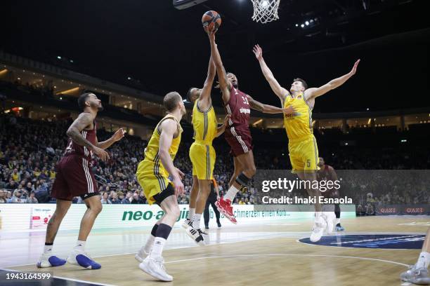 Devin Booker from FC Bayern Munich goes to the basket covered by Johannes Thiemann and Yannick Wetzell from Alba Berlin during the Turkish Airlines...