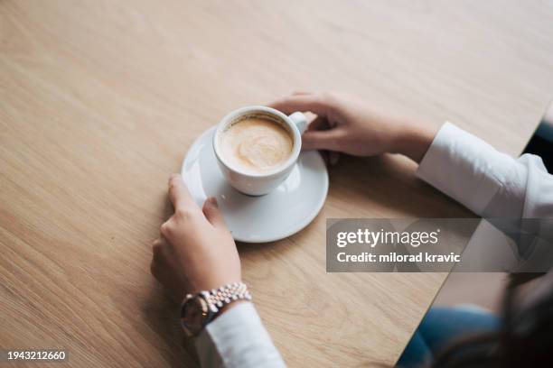 lady's hands holding coffee cup - hand resting on table stock pictures, royalty-free photos & images