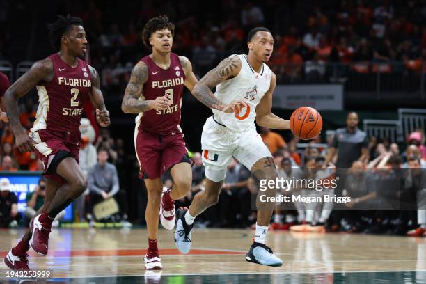 Matthew Cleveland of the Miami Hurricanes dribbles the ball against the Florida State Seminoles during the first half of the game at Watsco Center on...