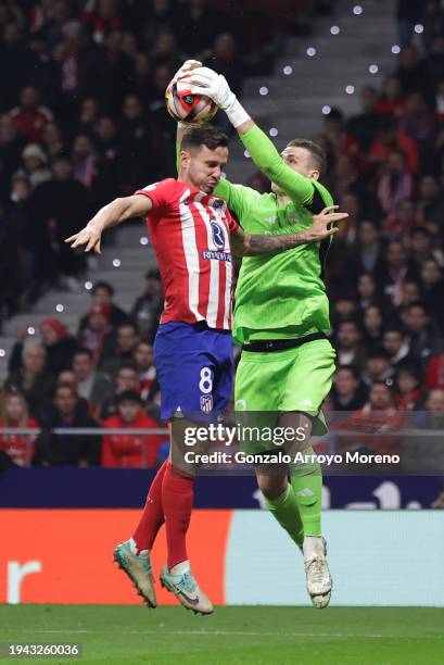 Andriy Lunin of Real Madrid saves a header from Saul Niguez of Atletico Madrid during the Copa del Rey Round of 16 match between Atletico Madrid and...