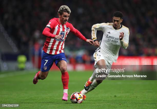 Antoine Griezmann of Atletico Madrid battles for possession with Jude Bellingham of Real Madrid during the Copa del Rey Round of 16 match between...