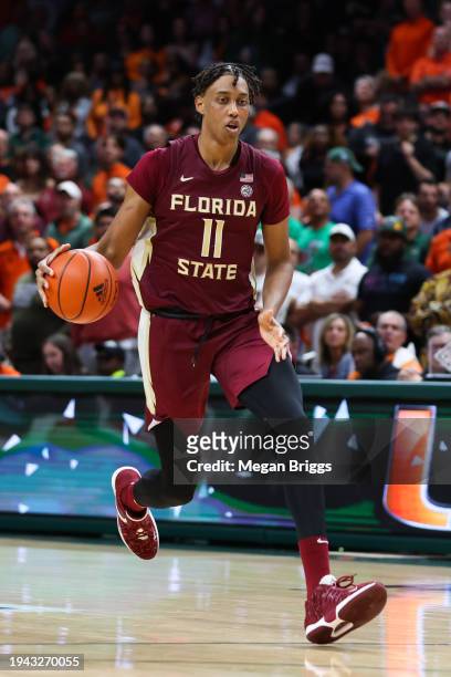 Baba Miller of the Florida State Seminoles dribbles the ball against the Miami Hurricanes during the second half of the game at Watsco Center on...