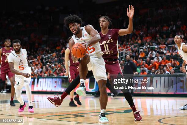Norchad Omier of the Miami Hurricanes rebound the ball against Baba Miller of the Florida State Seminoles during the second half of the game at...