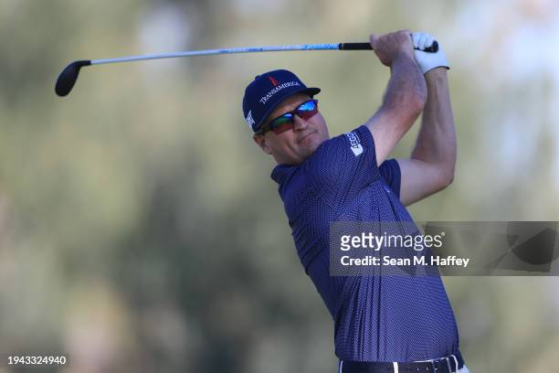 Zach Johnson of the United States hits a tee shot on the 18th hole during the first round of The American Express at La Quinta Country Club on...