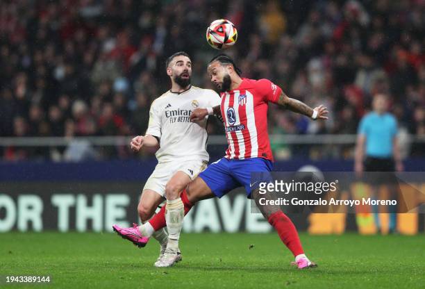 Memphis Depay of Atletico Madrid and Daniel Carvajal of Real Madrid battle for the ball during the Copa del Rey Round of 16 match between Atletico...