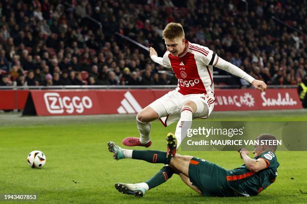 Ajax's Icelandic midfielder Kristian Hlynsson is tackled by Waalwijk's Belgian defender Dario van den Buijs during the Dutch Eredivisie football...