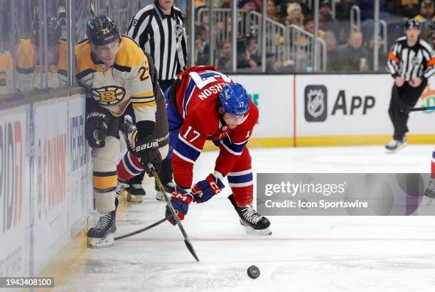 Montreal Canadiens right wing Josh Anderson pins Boston Bruins right defenseman Brandon Carlo to the boards during a game between the Boston Bruins...