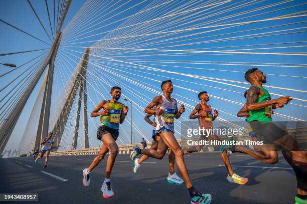 Athletes run on Bandra-Worli sea link bridge as they take part in a marathon on January 21, 2024 in Mumbai, India.
