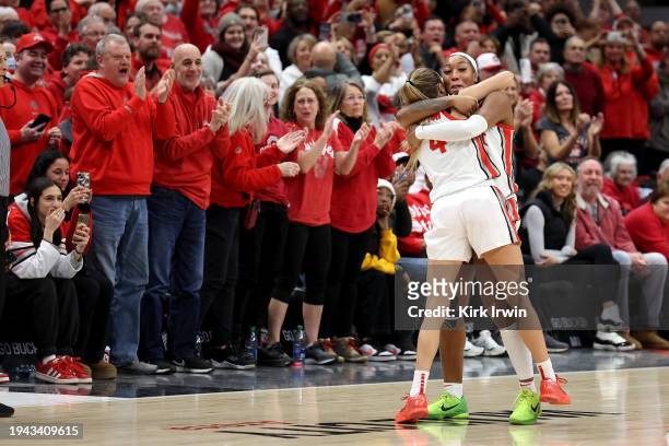 Cotie McMahon of the Ohio State Buckeyes congratulates Jacy Sheldon after defeating the Iowa Hawkeyes at Value City Arena on January 21, 2024 in...