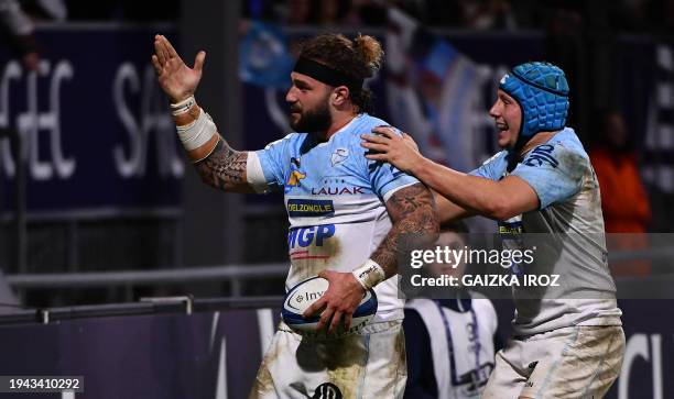 Bayonne's Italian centre Federico Mori and Bayonne's French centre Yan Lestrade react after scoring a try during the European Rugby Champions Cup...