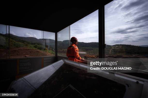 Firefighter stands at a viewpoint looking at the site where the Vale dam was located in Brumadinho, state of Minas Gerais, Brazil on January 19,...