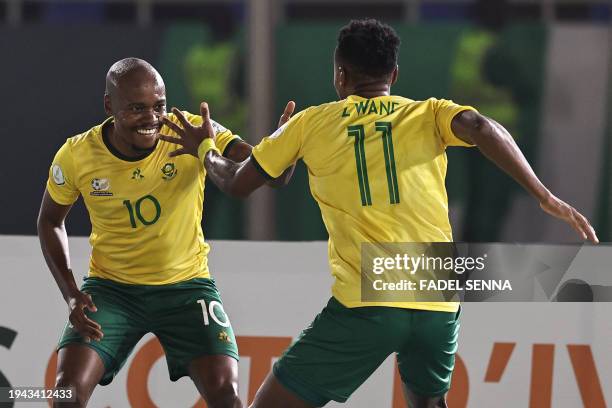 South Africa's forward Themba Zwane celebrates with teammates after scoring his team's third goal during the Africa Cup of Nations 2024 group E...