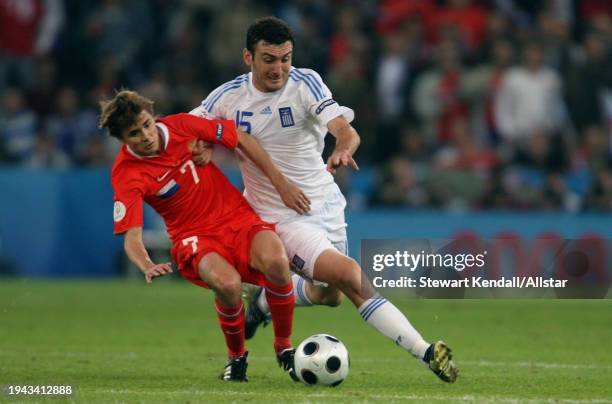 June 14: Dmitri Torbinski of Russia and Vassilis Torosidis of Greece challenge during the UEFA Euro 2008 Group D match between Greece and Russia at...