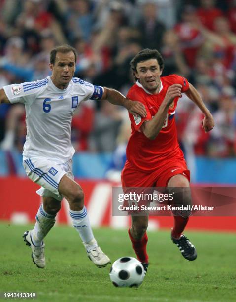 June 14: Angelos Basinas of Greece and Yuri Zhirkov of Russia challenge during the UEFA Euro 2008 Group D match between Greece and Russia at Em...
