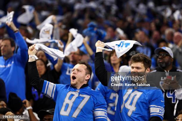 Detroit Lions fans cheer and swing towels in the air during the third quarter of an NFL divisional round playoff football game against the Tampa Bay...