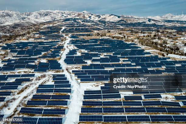 Photo taken in Yuncheng, China, on January 21 is showing the snowy scenery of the leading photovoltaic technology base on a barren mountain in...