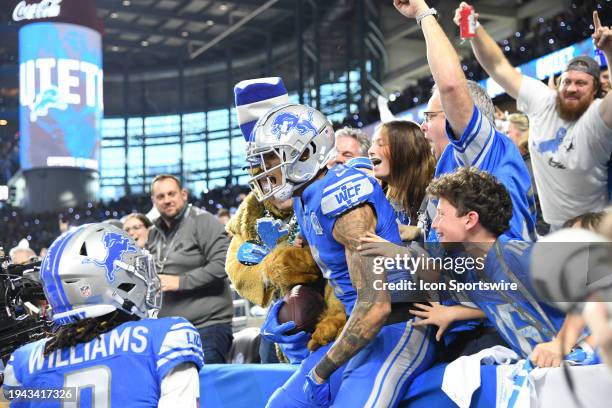 Detroit Lions wide receiver Josh Reynolds jumps into the stands the the fans following his touchdown reception in the second quarter during the NFC...