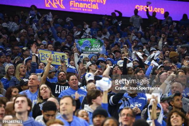 Fans hold up signs the say "Believe" and "Go Lions - America's Team" during an NFL NFC Divisional playoff football game between the Tampa Bay...