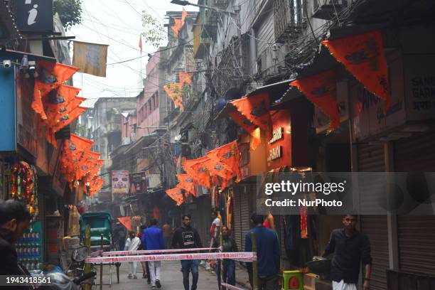 People are decorating a street with flags in Kolkata, India, on January 21 on the occasion of the inauguration of the Ram Mandir.