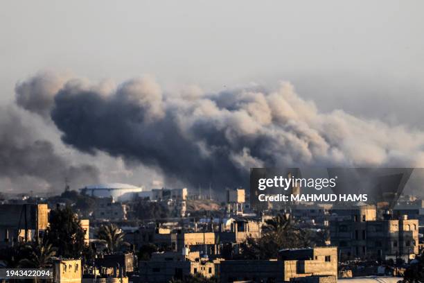 This photograph taken on January 22, 2024 from Rafah, shows smoke billowing during Israeli bombardment over Khan Yunis in the southern Gaza Strip,...