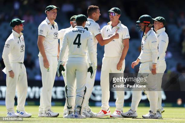 Josh Hazlewood of Australia celebrates with his team mates after taking the wicket of Gudakesh Motie of the West Indies during day three of the Mens...