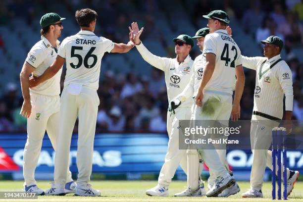 Mitchell Starc of Australia celebrates with his team mates after taking the wicket of Alzarri Joseph of the West Indies during day three of the Mens...