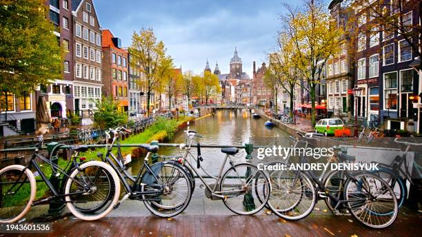 view of canal in amsterdam, holland. amstel river, canal, and bicycles. - amsterdam photos et images de collection