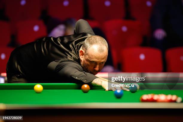 Mark Williams of Wales plays a shot in the quarterfinal match against Cao Yupeng of China on day 4 of the 2024 Spreadex World Grand Prix at...