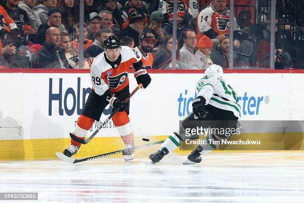 Cam Atkinson of the Philadelphia Flyers and Sam Steel of the Dallas Stars challenge for the puck during the third period at the Wells Fargo Center on...