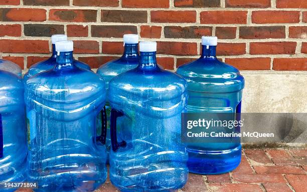 empty refillable water bottles placed outside for pickup - gallon stock pictures, royalty-free photos & images