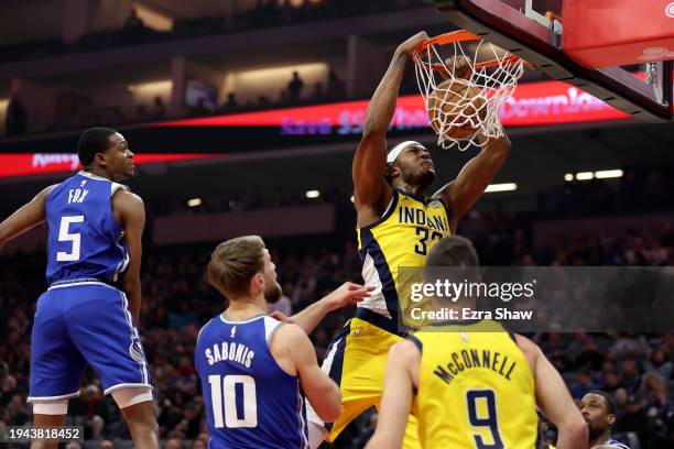 Myles Turner of the Indiana Pacers goes up for a dunk on Domantas Sabonis and De'Aaron Fox of the Sacramento Kings at Golden 1 Center on January 18,...
