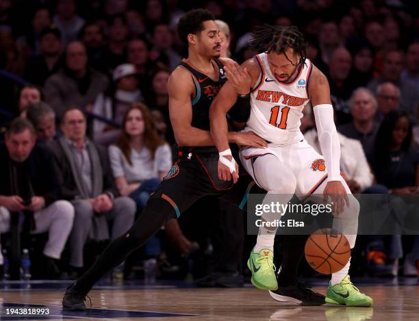 Jordan Poole of the Washington Wizards and Jalen Brunson of the New York Knicks fight for position at Madison Square Garden on January 18, 2024 in...