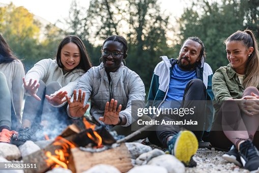 Diverse Friends Enjoying a Campfire Outdoors