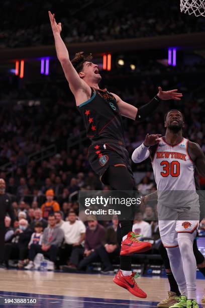 Deni Avdija of the Washington Wizards reacts after his basket as Julius Randle of the New York Knicks defends at Madison Square Garden on January 18,...