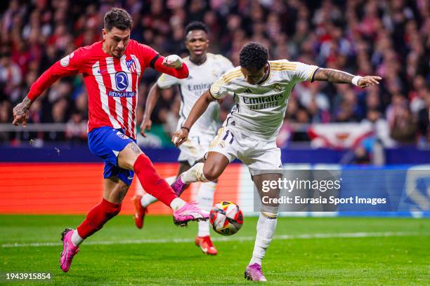 Jose Gimenez of Atletico de Madrid attempts a kick while being defended by Rodrygo Goes of Real Madrid during Copa del Rey Round of 16 match between...
