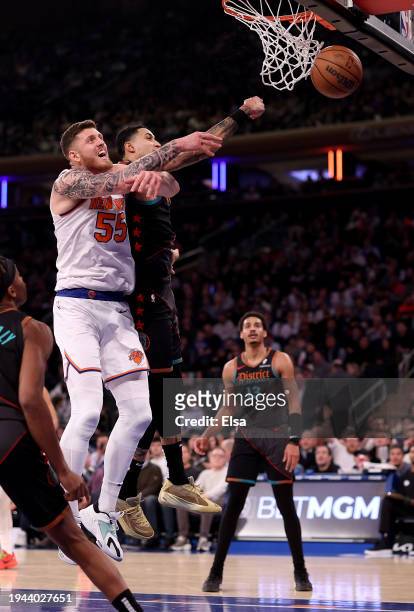 Isaiah Hartenstein of the New York Knicks and Kyle Kuzma of the Washington Wizards go after the ball at Madison Square Garden on January 18, 2024 in...