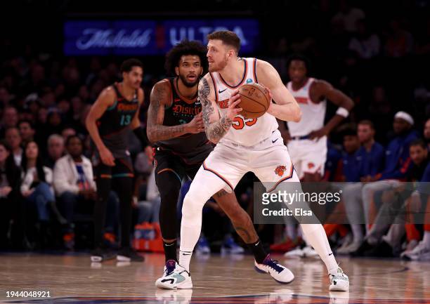 Isaiah Hartenstein of the New York Knicks looks to pass as Marvin Bagley III of the Washington Wizards defends at Madison Square Garden on January...