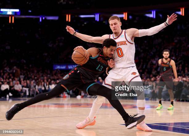 Jordan Poole of the Washington Wizards drives to the net as Donte DiVincenzo of the New York Knicks defends at Madison Square Garden on January 18,...