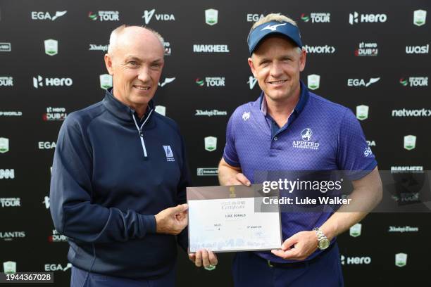 Luke Donald of England is presented with an award for his hole in one on the fourth hole after finishing his round during Round Two of the Hero Dubai...