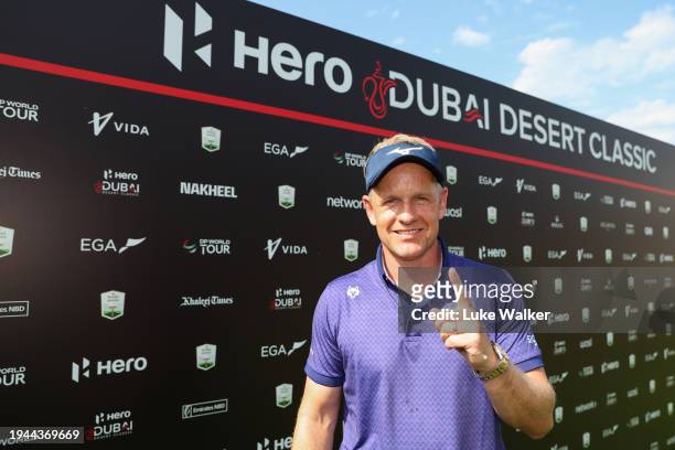 Luke Donald of England poses for a photo after being presented with an award for his hole in one on the fourth hole after finishing his round during...